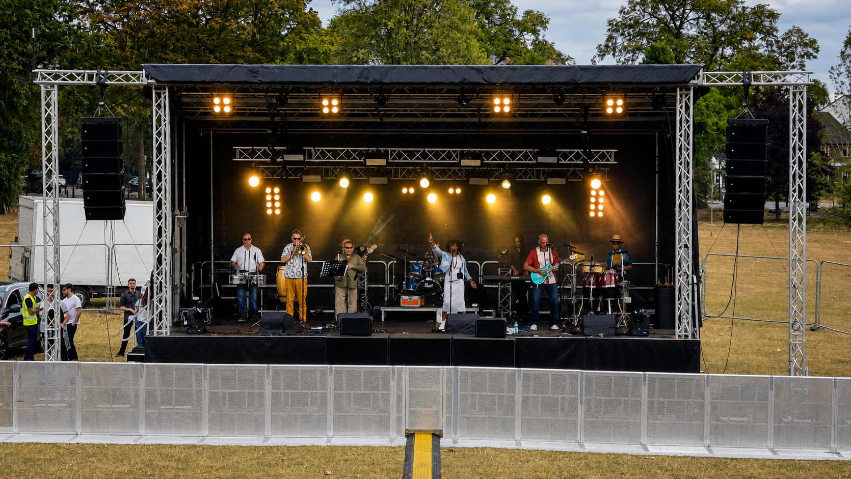 JK Productions lighting an outdoor live music stage with warm amber fixtures and haze